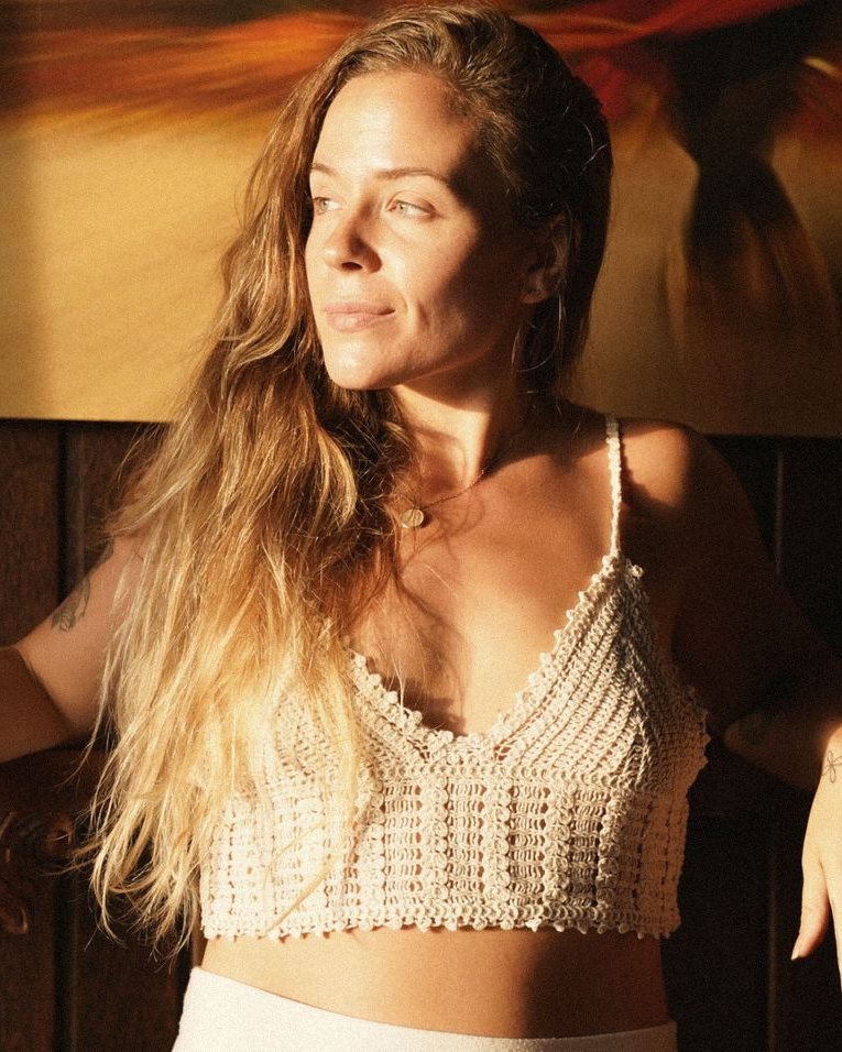 Heather in golden light, looking away from the camera